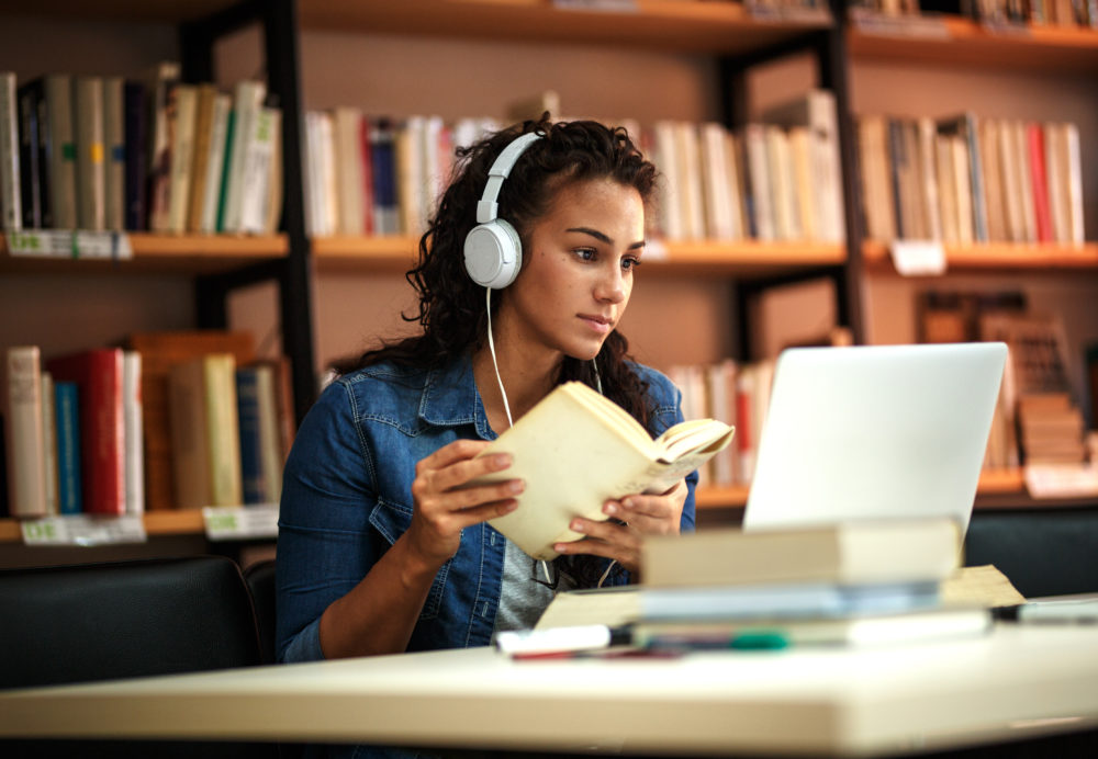 Student reading at laptop